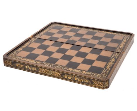 A 19th century Chinese black lacquer folding chess/backgammon board: the external chess board enclosed by a foliate border, w