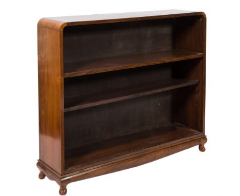 A mid 20th Century Indian rosewood open bookcase:, with curved top, fitted with a fixed and an adjustable shelf, on short cab
