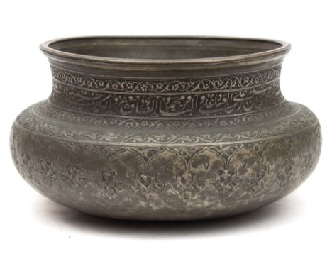 A Persian Safavid tinned copper bowl: of rounded form with waisted neck, engraved and chased with bands of foliage and callig