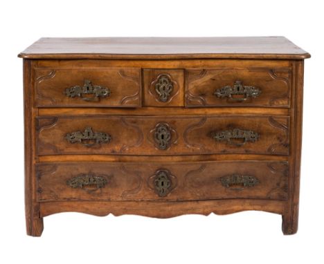 An 18th Century French Provincial walnut serpentine fronted commode:, the top with a moulded edge, containing two short and t