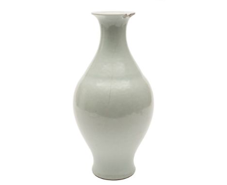 A Chinese pale celadon glazed vase: of baluster form with pear shaped body and flared rim, underglaze blue Qianlong seal mark