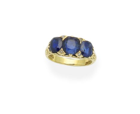 Sapphire and diamond three-stone ringSet with three cushion-shaped sapphires, accented by rose-cut diamonds, the gallery of s