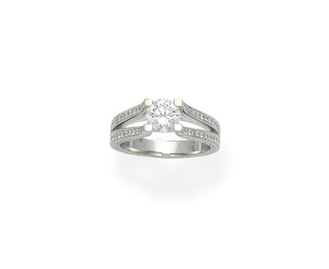 Diamond ringThe brilliant-cut diamond between similarly-cut diamond bifurcated shoulders, the gallery and base of the band en