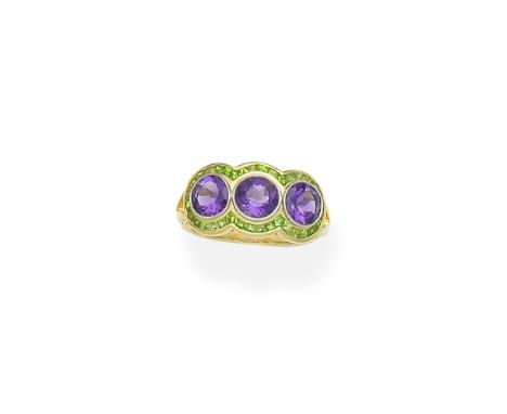 Amethyst and demantoid garnet three-stone ringSet with circular-cut amethysts within a calibré-cut demantoid garnet surround,