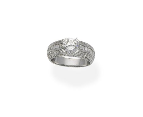 Diamond ringThe brilliant-cut diamond between bombé shoulders set with similarly and step-cut diamonds, principal diamond app