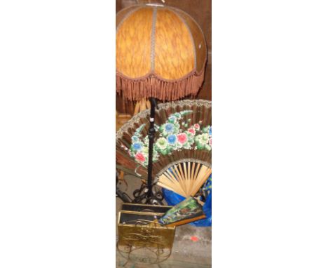 Wrought iron standard lamp with shade, two magazine racks, a large bamboo and painted paper fan and another