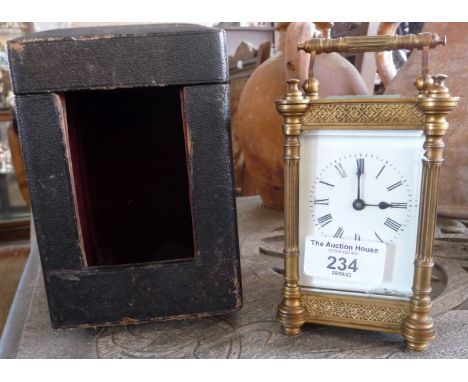 19th c. gilt brass carriage clock having four column body (crack to glass) with leather case and key, 6" tall