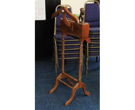 A late 20th Century wooden suit stand with drawer compartments, together with a carved wooden nut cracker.
