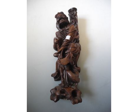A carved Chinese figure lamp (without fittings).