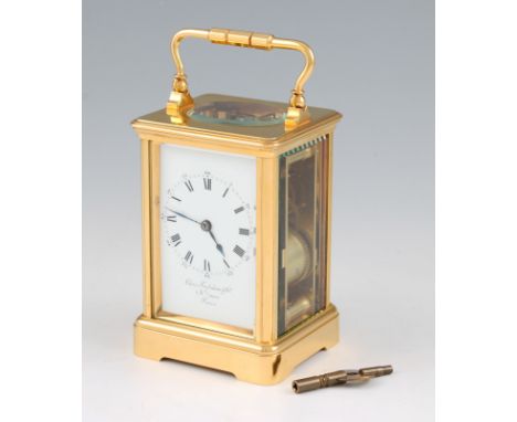 A brass bodied carriage clock with twin barrel movement, the white enamel dial having black Roman numeral hourly markers with