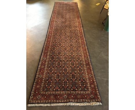 A large Persian runner. 390 x 92cm