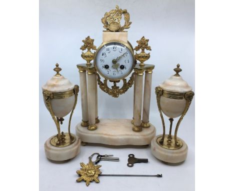 An early 20th century French marble mantle clock and garniture with enameled dial and ormolu mount with 2 x keys&nbsp;