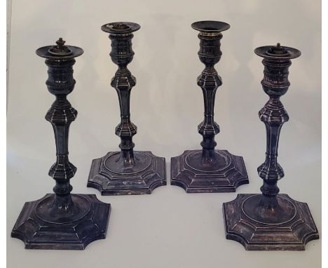Four silver plated candlesticks, by Elkington &amp; Co, the sconces with inserts for electric light fittings, height ex. fitt