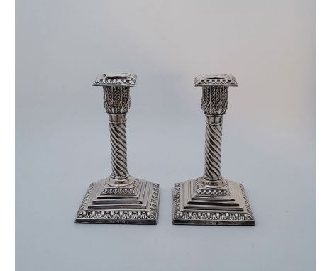 A pair of Victorian silver candlesticks, by Jane Brownett, London 1886,  having egg and dart type square nozzle above foilate