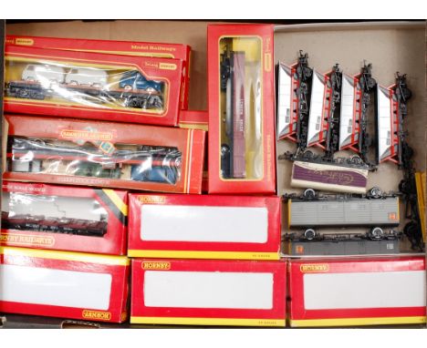 15 boxed and 8 unboxed Hornby wagons, including 5 boxed and 4 unboxed MGR hopper wagons, 2 bogie transporters with Minix cars