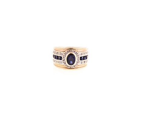 A SAPPHIRE AND DIAMOND RING the broad band centred with an oval mixed-cut sapphire weighing approximately 0.81cts, within a s