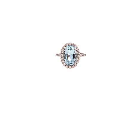 AN AQUAMARINE AND DIAMOND RING centred with an oval mixed-cut aquamarine weighing approximately 3.54cts, the shoulders and co