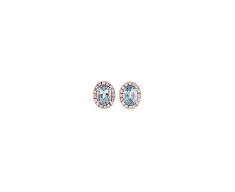 A PAIR OF AQUAMARINE AND DIAMOND EAR STUDS each centred with an oval mixed-cut aquamarine weighing approximately 4.58cts in t