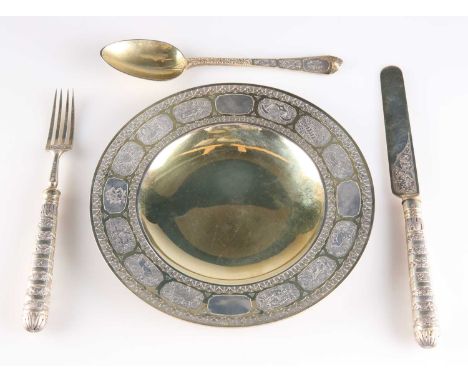 A RARE VICTORIAN SILVER-GILT CHRISTENING SET by Charles Edwards, 1879-1881, comprising plate, knife, fork and spoon, decorate