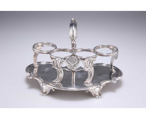 † A VICTORIAN SILVER CRUET STAND Benjamin Smith III (probably), London 1840, for four bottles, scrolling kidney shape with st