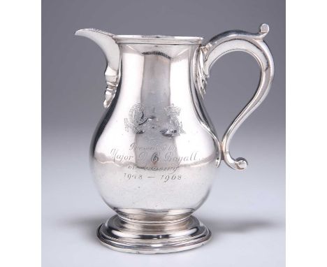 † AN ELIZABETH II SILVER MILK JUG by Richard Comyns, London 1971, of large proportions, baluster form with S-scroll handle, r