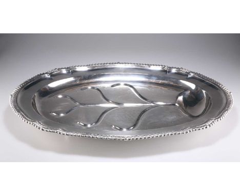 A LARGE WILLIAM IV SILVER WELL AND TREE PLATTER by R &amp; S Garrard &amp; Co, London 1831, shaped oval, with heavily gadroon