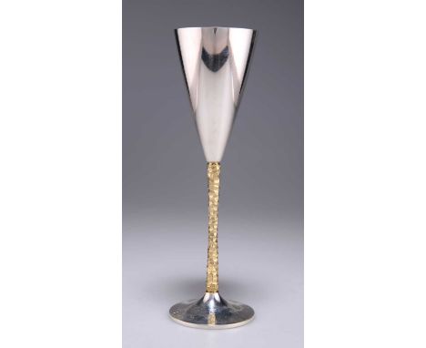 STUART DEVLIN (1931-2018), AN ELIZABETH II PARCEL-GILT SILVER CHAMPAGNE FLUTE by Stuart Devlin, London 1980, with a conical b