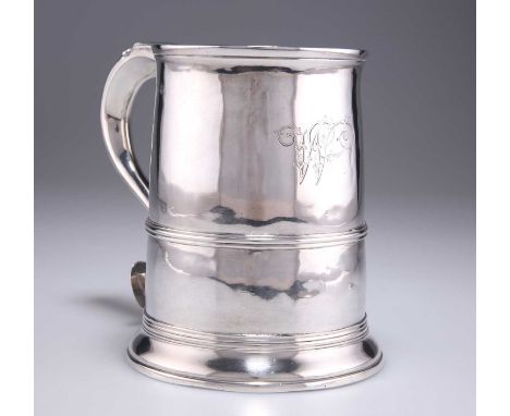 A LARGE GEORGE III SILVER TANKARD maker ?W, London 1765, with reeded girdle and S-scroll handle, engraved with a W. 15cm high