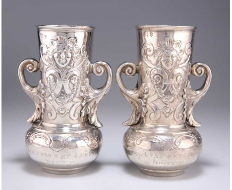 A PAIR OF 19TH CENTURY TWIN-HANDLED VASES possibly German, marks indistinct, of squat form with long cylindrical necks and le