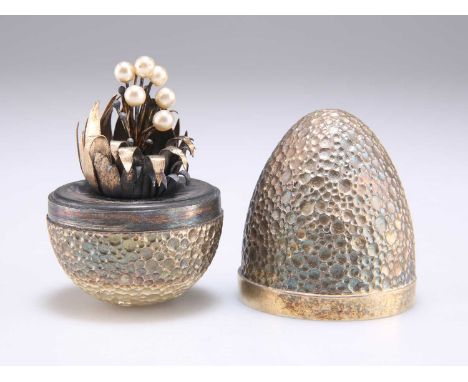 STUART DEVLIN: AN ELIZABETH II SILVER-GILT SURPRISE EGG by Stuart Devlin, London 1977, the textured egg opening to reveal a '