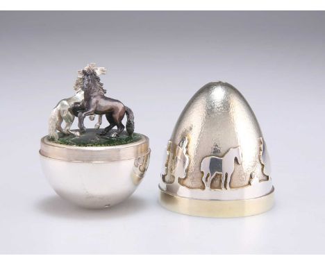 STUART DEVLIN: AN ELIZABETH II SILVER-GILT SUPRISE EGG by Stuart Devlin, London 1988, the textured and bright polished egg de