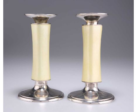 A PAIR OF SWISS STERLING SILVER AND ENAMEL CANDLESTICKS by Meister, Zurich, c.1960, on slightly domed circular bases, the wai