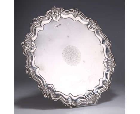 A GEORGE V SILVER SALVER by Walker &amp; Hall, Sheffield 1911, shaped circular with a scalloped foliate and floral-moulded ed