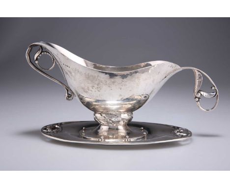 A GEORG JENSEN STERLING SILVER SAUCEBOAT, STAND AND LADLE import mark, George Stockwell, London 1929, in the Blossom pattern,