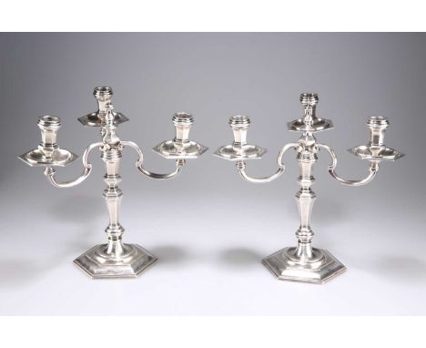 A PAIR OF GEORGIAN-STYLE CAST SILVER CANDELABRA  by Spink &amp; Son, London 1972, the three-branch detachable superstructures