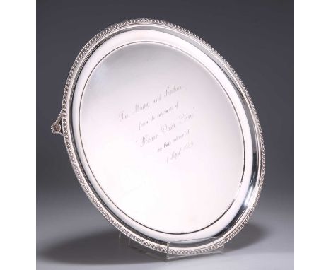AN ELIZABETH II SILVER SALVER by C J Vander Ltd, Sheffield 1988, circular with beaded rim, raised on three beaded bracket fee