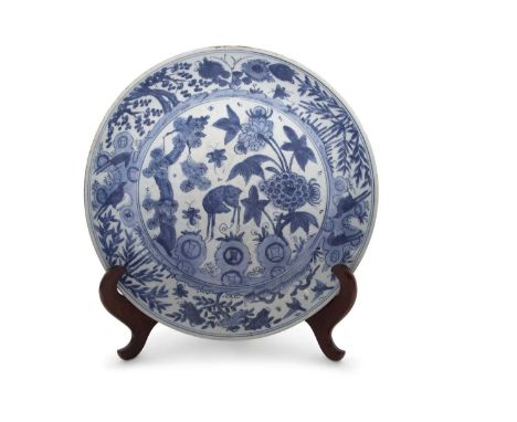 A large Chinese porcelain charger Qing Dynasty with a blue and white Kangxi style design of a deer amongst flowers and bamboo