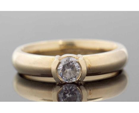 An 18ct certificated diamond ring, the round brilliant cut diamond, 0.33cts, tension set to a 4mm wide plain band hallmarked 