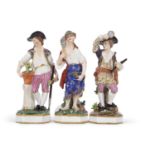 A group of three 19th Century Derby figures including a gardener and a musician and a fish seller,