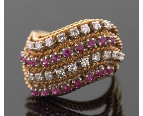 An 18ct diamond and ruby ring, set with four alternating curving diagonal rows of rubies and diamonds, separated by textured 