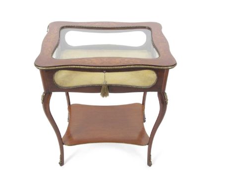 A late 19th Century continental bijouterie table with hinged serpentine top opening to a fabric lined interior, the body supp