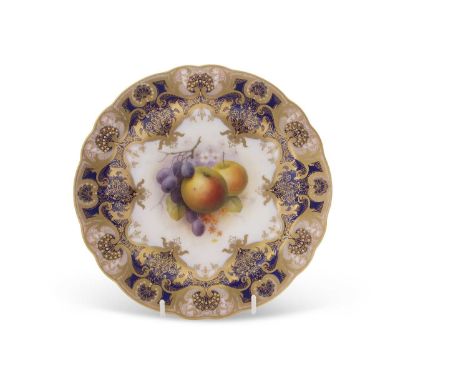 A Royal Worcester cabinet plate, the centre finely painted with fruit by Albert Shuck within blue and gilt border and shaped 