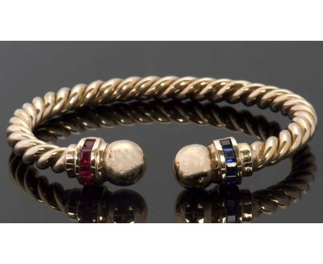 A gemset torque bangle, the twisted torque style bangle with a half hoop of channel set synthetic sapphires and synthetic rub