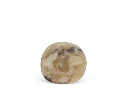 A jade pendant with dragon carving with brown occlusions, 4cm diameter