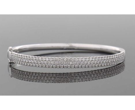 An 18ct diamond bangle, the white gold hinged bangle set to upper half with round brilliant cut diamonds, total 2.31cts, the 