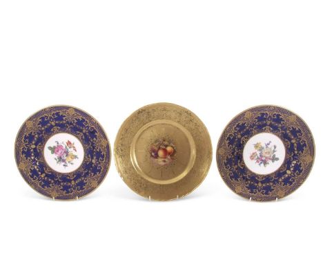 A Royal Worcester gilt decorated cabinet plate, the centre painted with fruit, signed by J Skerritt together with two coversw