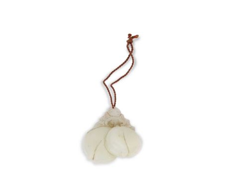 A jade carving of peaches with a carved bat above