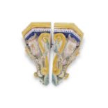 Two Italian faience style corner shelves, both decorated in Majolica glazes with satyrs, 35cm high