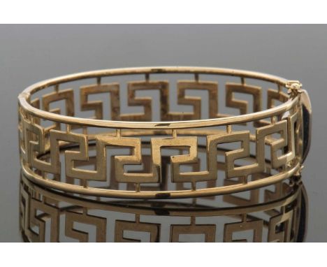 A 9ct Greek key bangle, the hinged bangle with open work Greek key design, stamped 375 with Birmingham import mark, concealed