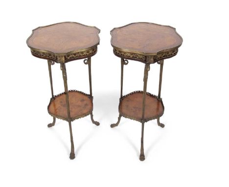 A pair of late 19th Century continental Empire style walnut and brass mounted lamp tables, set on brass legs with eagles head